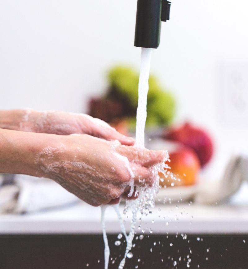 Hands being washed in clean running water