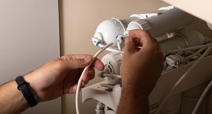 Hands fixing water softener