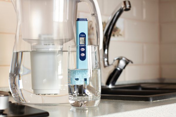 Measurement of TDS of water. Electronic pH meter in a glass of soft water.