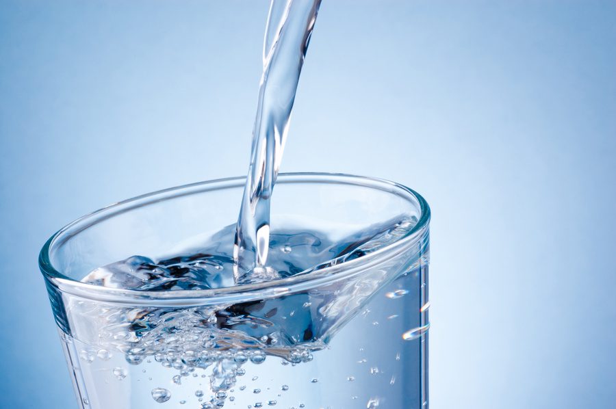 Pouring filtered drinking water into glass